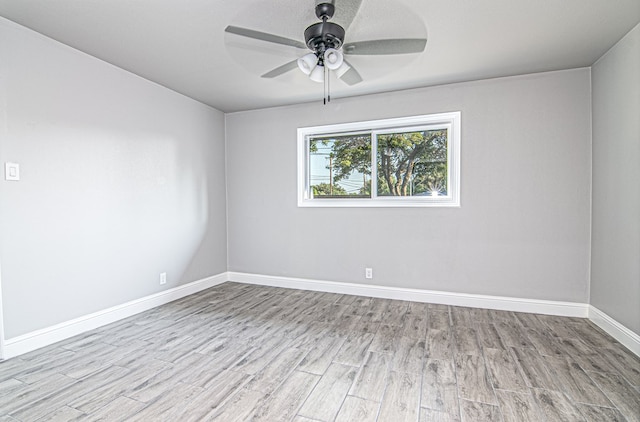 unfurnished room featuring wood finished floors, baseboards, and ceiling fan