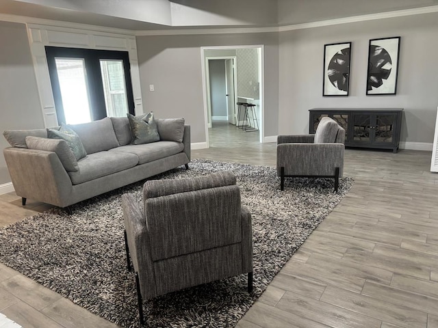 living area featuring baseboards and wood finished floors