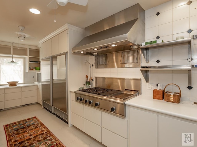 kitchen with range hood, tasteful backsplash, decorative light fixtures, white cabinetry, and stainless steel appliances