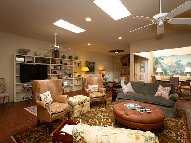 living room featuring lofted ceiling with skylight