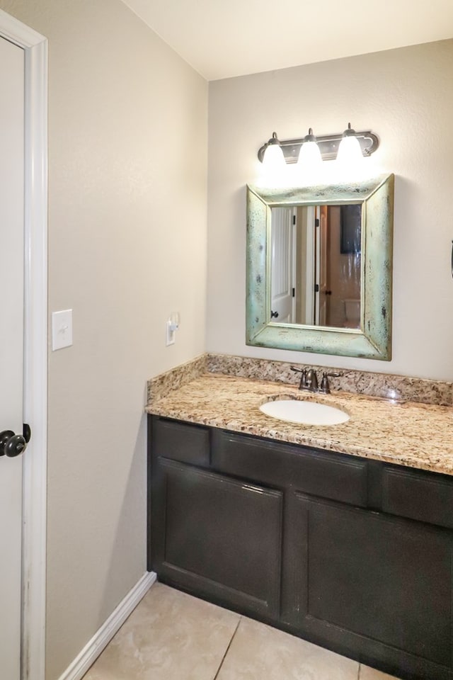 bathroom featuring tile patterned flooring and vanity