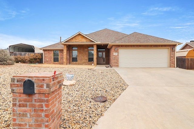 view of front facade with a garage and a carport