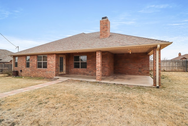 rear view of property with a patio area and a lawn