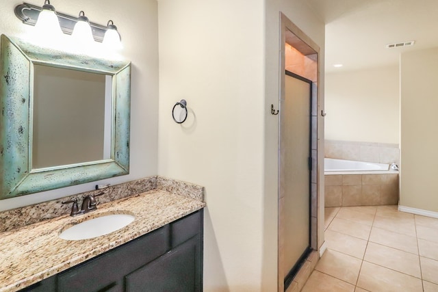 bathroom with tile patterned floors, separate shower and tub, and vanity