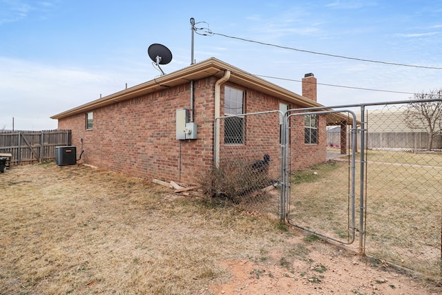 view of side of home with central AC unit