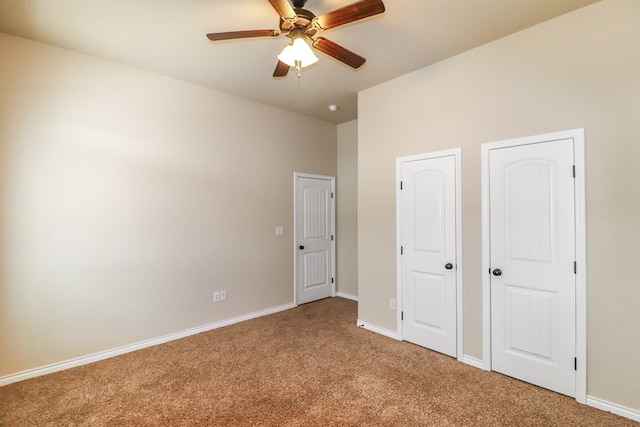 unfurnished bedroom featuring carpet and ceiling fan