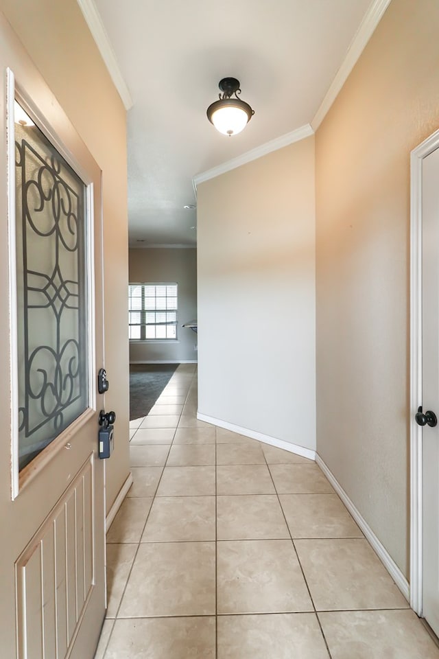 corridor with ornamental molding and light tile patterned floors