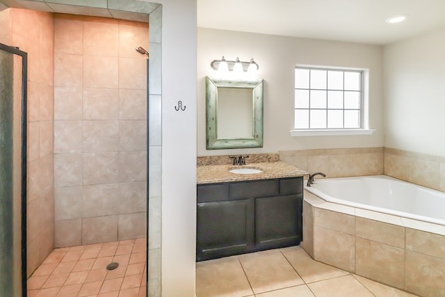 bathroom with tile patterned floors, vanity, and separate shower and tub