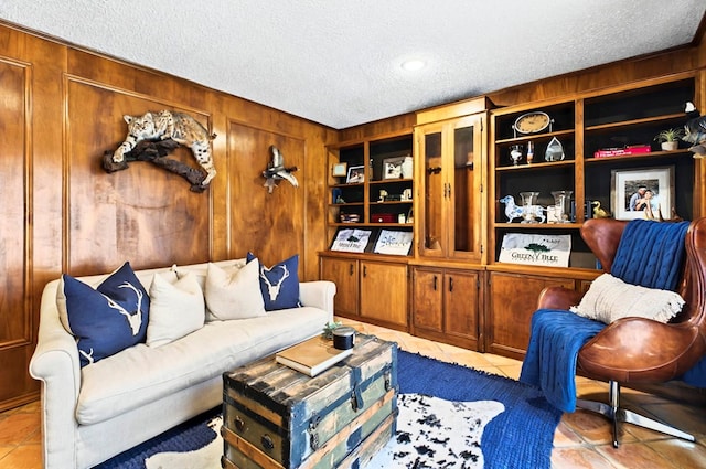 2401 Metz Pl, Midland, TX 79705 - living area with a textured ceiling, light tile patterned floors, and wood walls