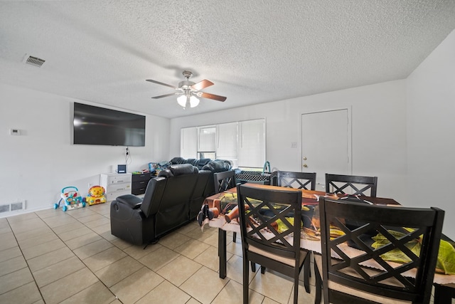 704 Birdwell Ln, Big Spring, TX 79720 - dining space with a ceiling fan, light tile patterned flooring, and a textured ceiling