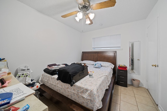 704 Birdwell Ln, Big Spring, TX 79720 - bedroom with a ceiling fan, light tile patterned floors, and a textured ceiling