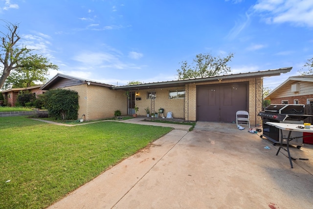 704 Birdwell Ln, Big Spring, TX 79720 - single story home featuring driveway, a garage, a front lawn, and brick siding