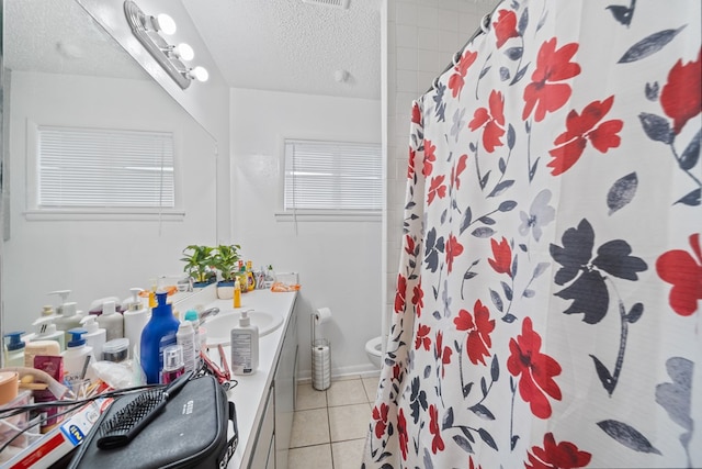 704 Birdwell Ln, Big Spring, TX 79720 - bathroom featuring a textured ceiling, vanity, tile patterned floors, and a shower with curtain