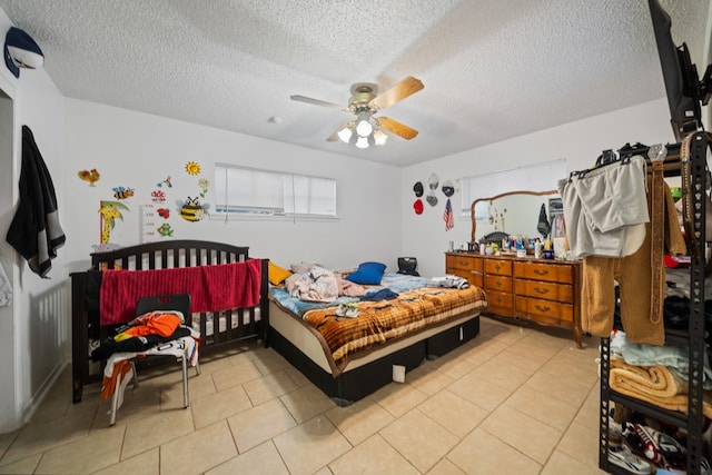 704 Birdwell Ln, Big Spring, TX 79720 - bedroom with a textured ceiling, a ceiling fan, and light tile patterned floors