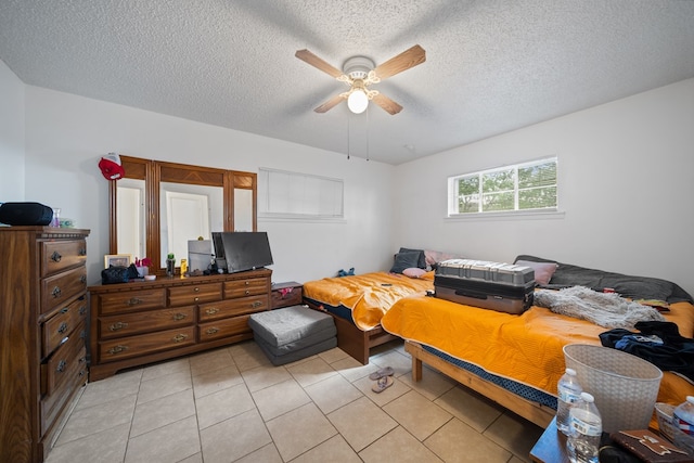 704 Birdwell Ln, Big Spring, TX 79720 - bedroom featuring a textured ceiling, light tile patterned flooring, and ceiling fan