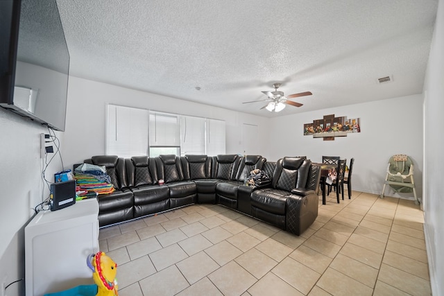704 Birdwell Ln, Big Spring, TX 79720 - living room featuring light tile patterned floors, ceiling fan, and a textured ceiling