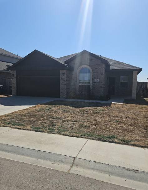 ranch-style home with a garage and concrete driveway