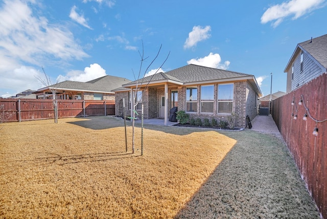 rear view of property featuring a patio area and a yard