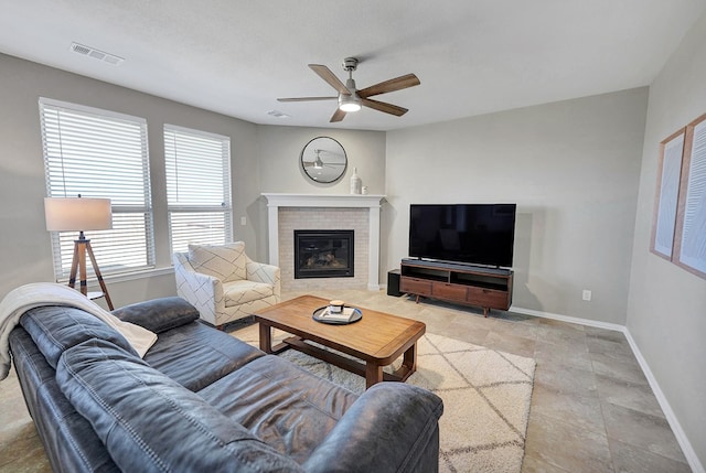 living room with ceiling fan and a textured ceiling