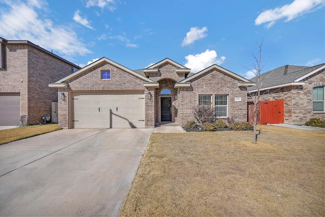 view of front of house featuring a garage and a front lawn