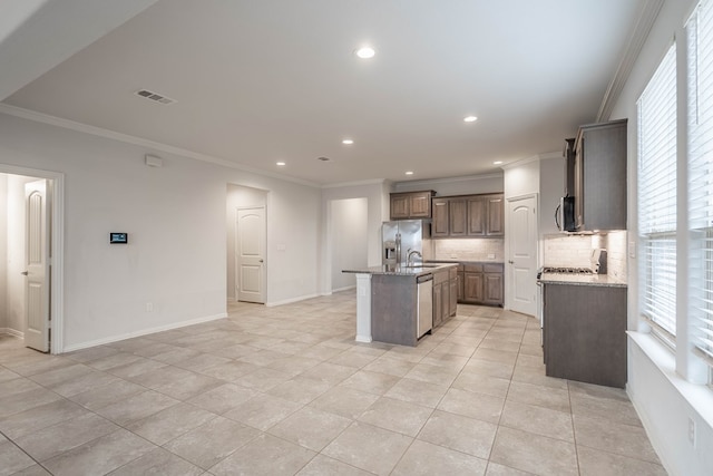 1215 Santa Clara, Midland, TX 79705 - kitchen featuring stainless steel appliances, crown molding, decorative backsplash, an island with sink, and recessed lighting