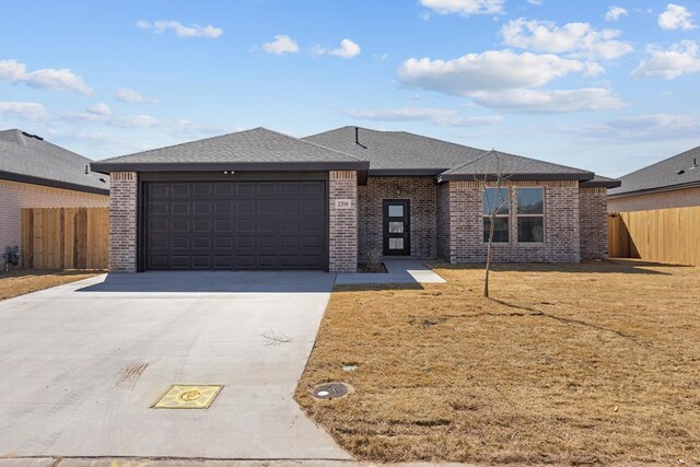 2708 Beachwood St, Midland, TX 79706 - view of front facade with brick siding, an attached garage, concrete driveway, and a shingled roof