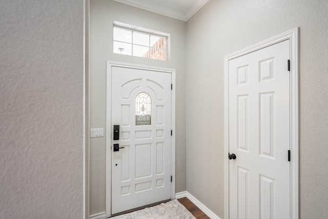 foyer entrance with hardwood / wood-style floors and ornamental molding