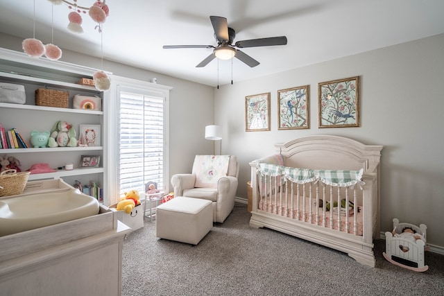 bedroom featuring ceiling fan, carpet floors, and a nursery area