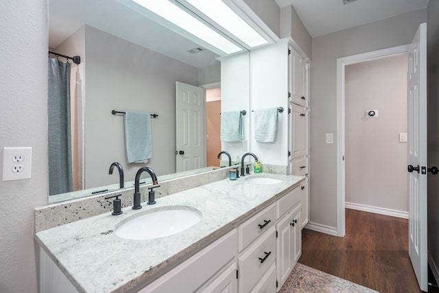 bathroom with hardwood / wood-style floors and vanity