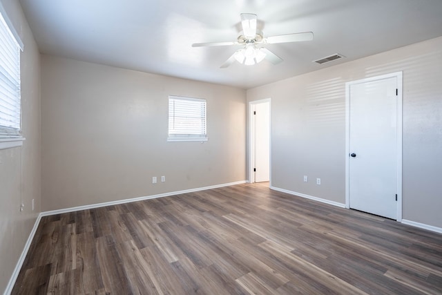 unfurnished room with dark hardwood / wood-style floors and ceiling fan