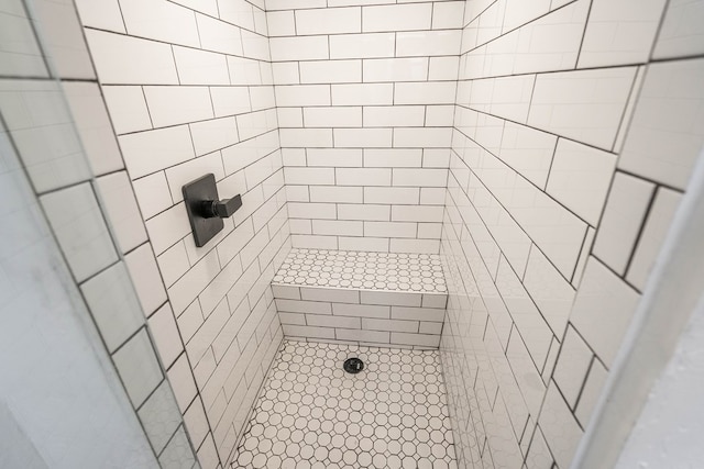 bathroom with tiled shower