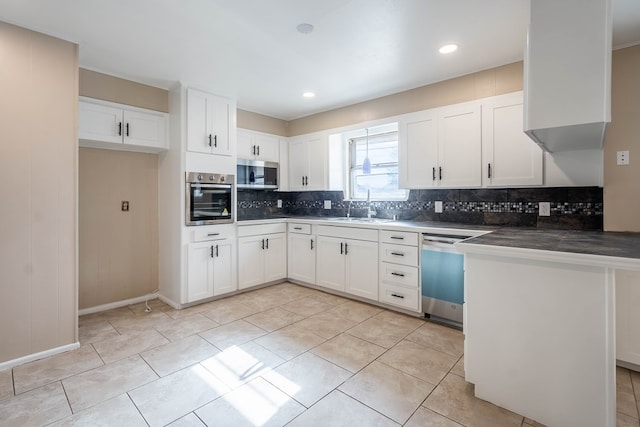 kitchen featuring kitchen peninsula, white cabinetry, sink, and appliances with stainless steel finishes