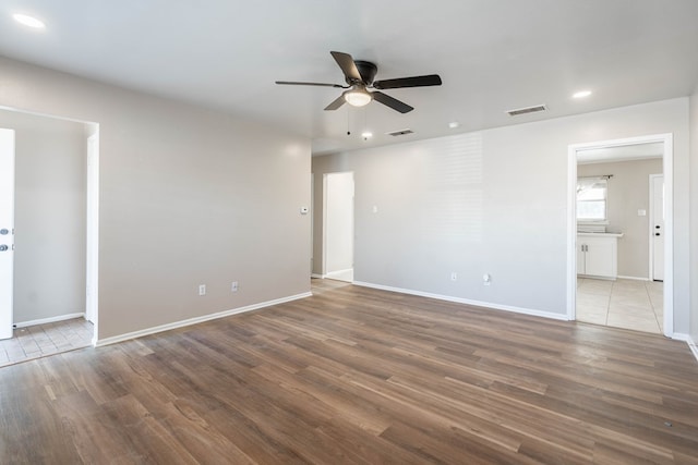 spare room with ceiling fan and hardwood / wood-style floors