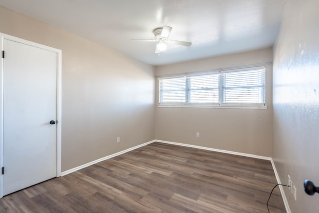 spare room with ceiling fan and dark wood-type flooring