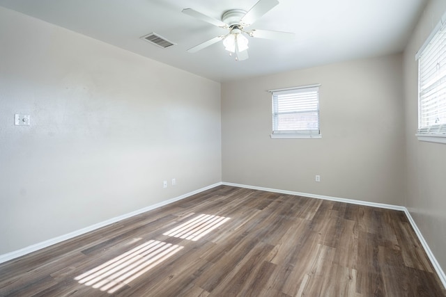 spare room featuring ceiling fan and dark hardwood / wood-style flooring