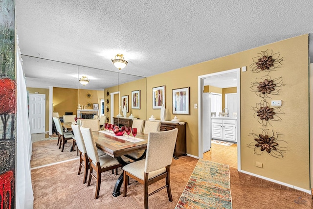 3409 Wedgwood, Midland, TX 79707 - dining room with light colored carpet, a textured ceiling, and baseboards
