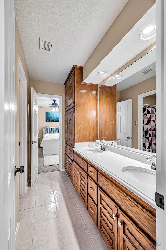 3409 Wedgwood, Midland, TX 79707 - ensuite bathroom featuring tile patterned floors, visible vents, a sink, and ensuite bath