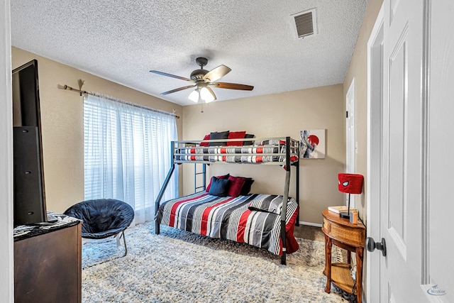 3409 Wedgwood, Midland, TX 79707 - bedroom featuring visible vents, a ceiling fan, a textured ceiling, and carpet flooring