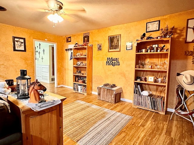 office area with wood-type flooring and ceiling fan