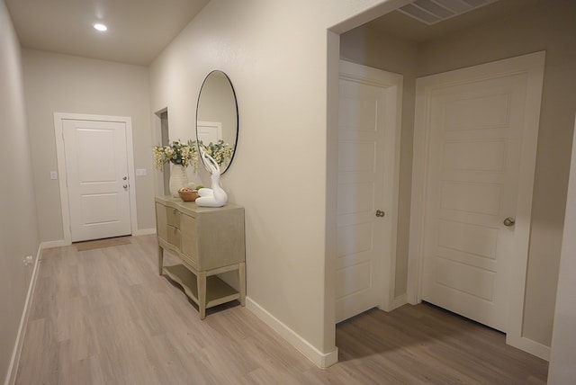 corridor featuring light hardwood / wood-style floors