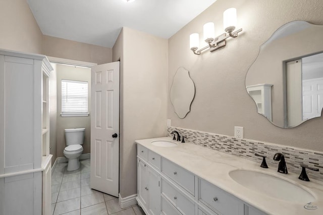 bathroom with vanity, decorative backsplash, tile patterned floors, and toilet