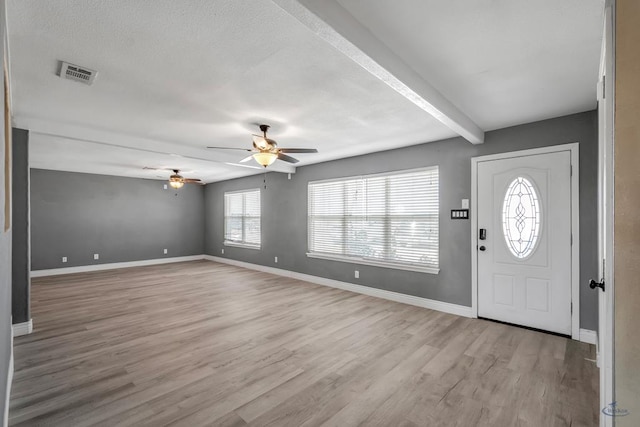 entryway featuring beam ceiling, ceiling fan, and light wood-type flooring