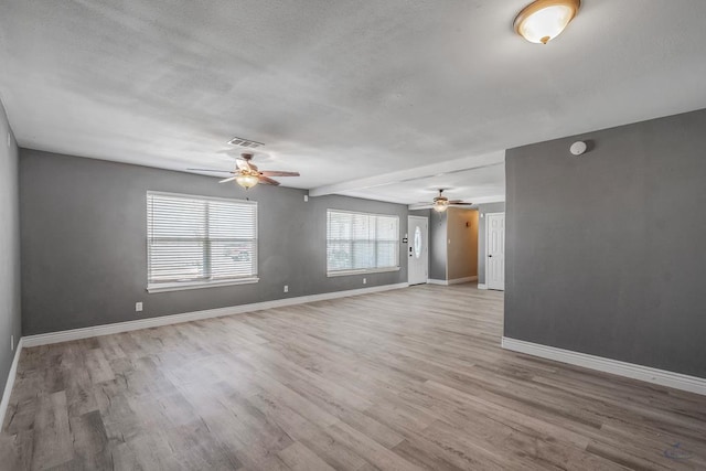 spare room with ceiling fan and light hardwood / wood-style flooring