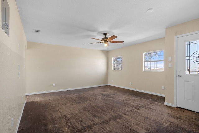 foyer entrance with a textured ceiling, ceiling fan, and dark hardwood / wood-style floors