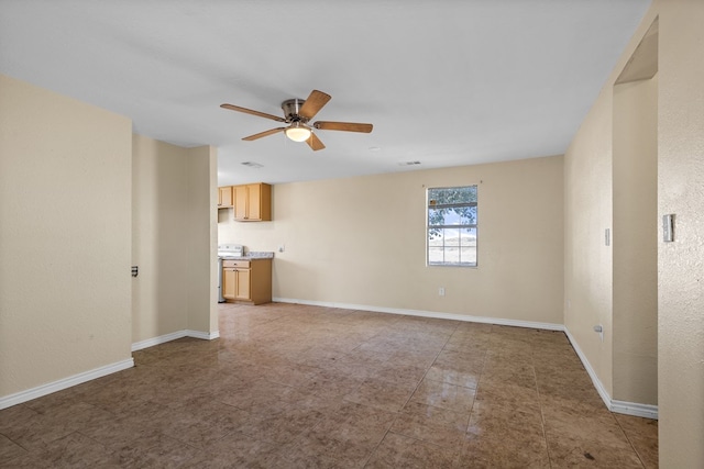 unfurnished living room with ceiling fan