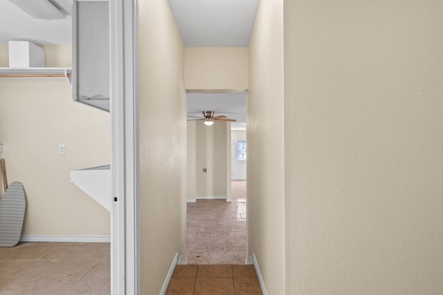 hall featuring light tile patterned flooring