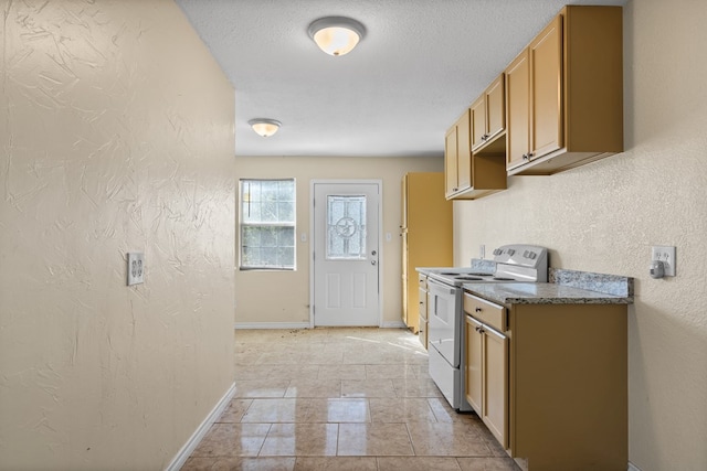 kitchen featuring light tile patterned flooring, a textured ceiling, and electric stove