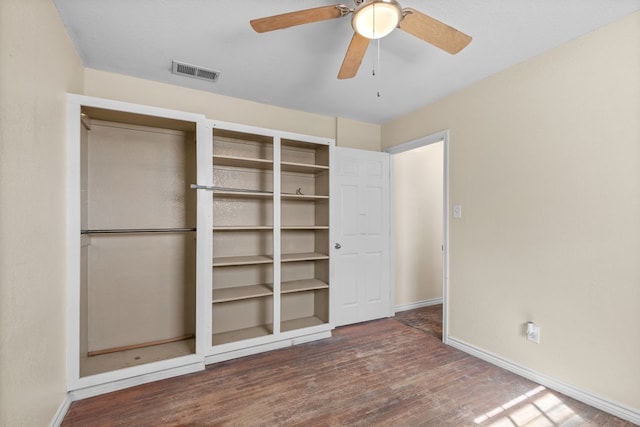 unfurnished bedroom with a closet, dark hardwood / wood-style floors, and ceiling fan