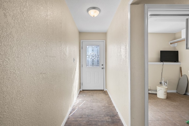 doorway to outside with light wood-type flooring