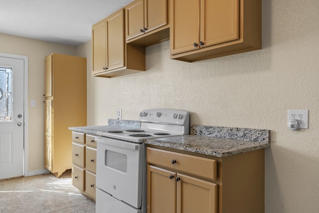 kitchen featuring light stone counters, white appliances, a textured ceiling, and light tile patterned floors